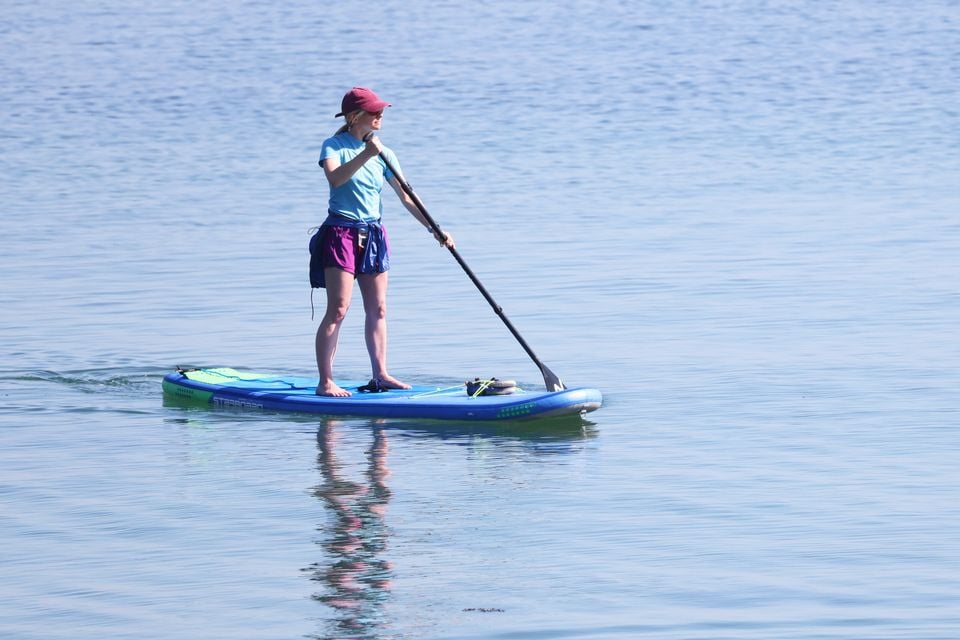 A paddle boarder makes the most of the the warm weather at Helens Bay, last week  (Photo by Peter Morrison)